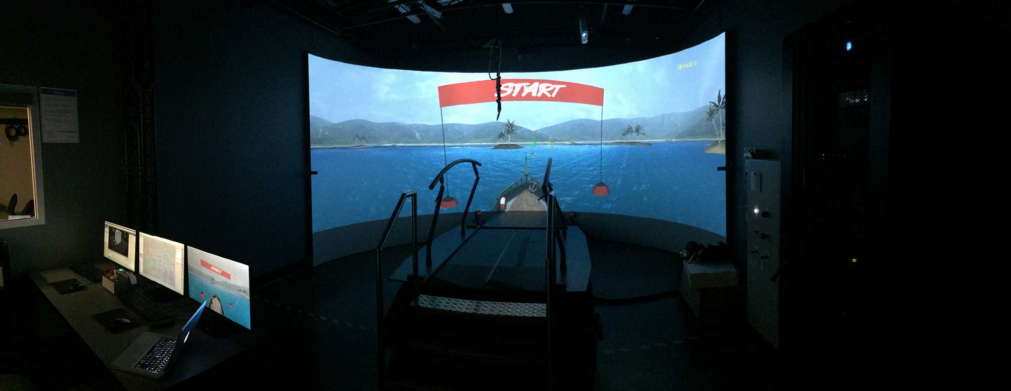 A virtual reality boat on water displays on the enormous curved screen that surrounds the rehab treadmill