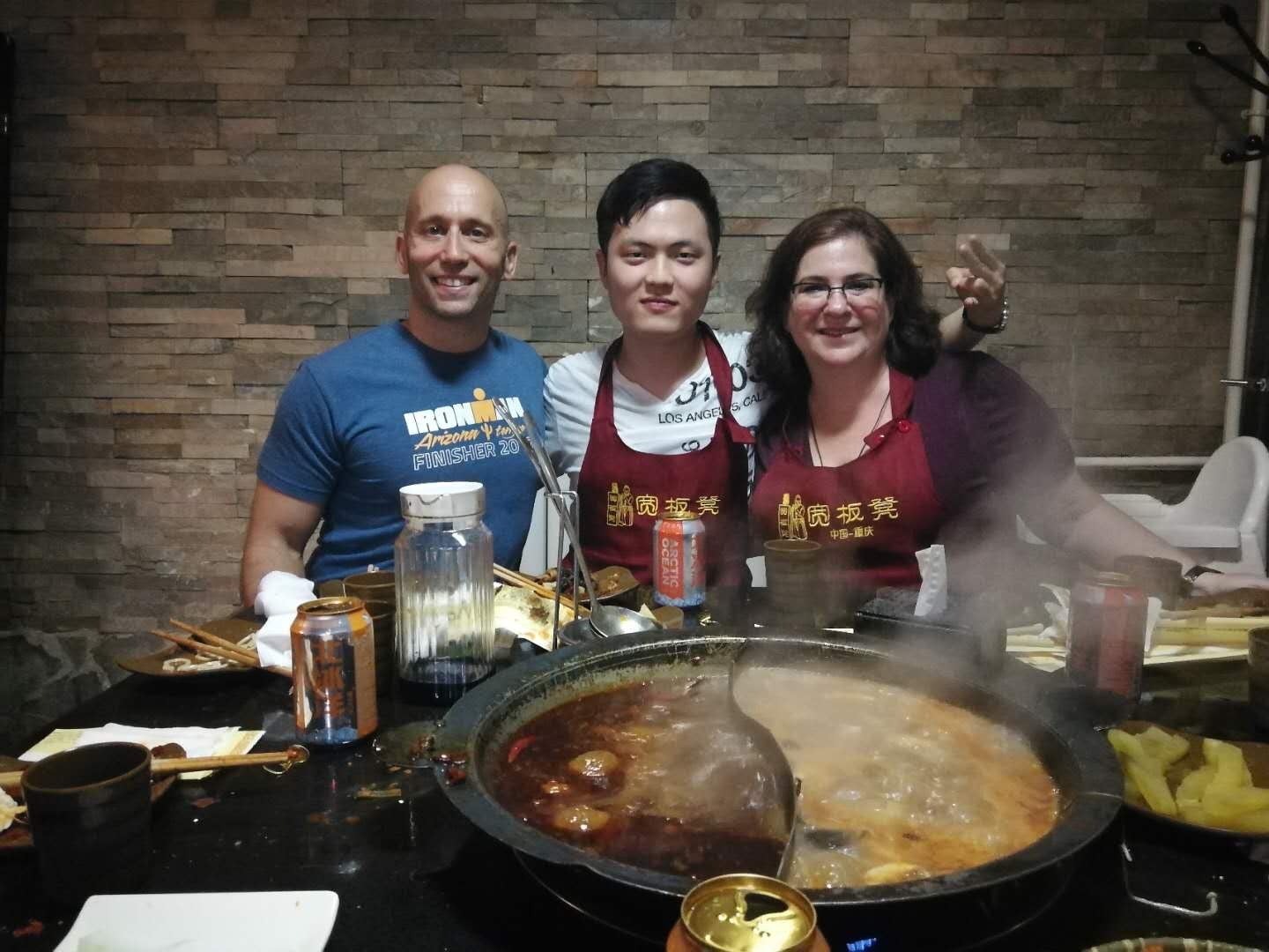Dr. B and Dr. Hirshorn surround Hao while enjoying Hotpot in Beijing