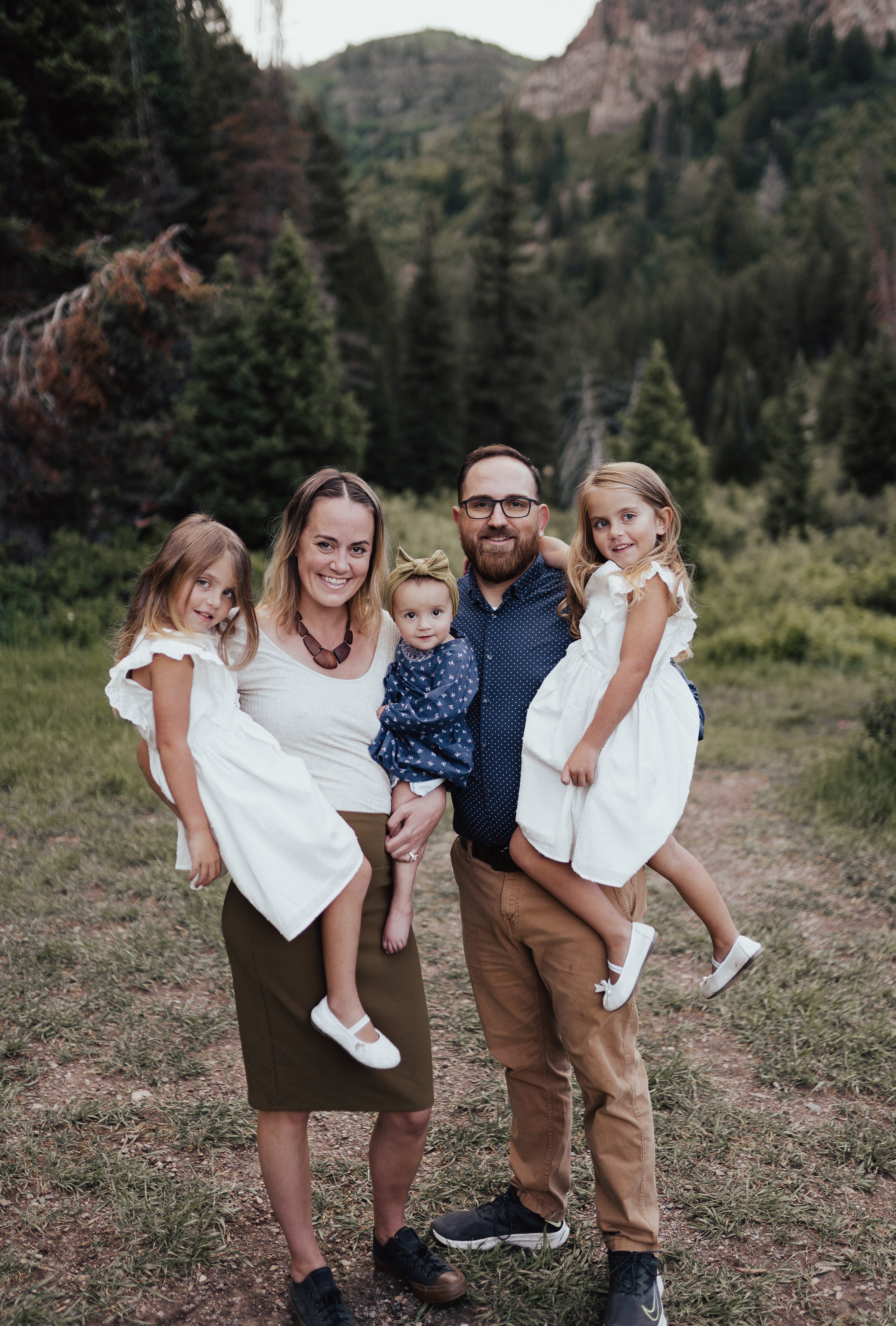 Zach, his wife, and three daughters in the mountains of Utah
