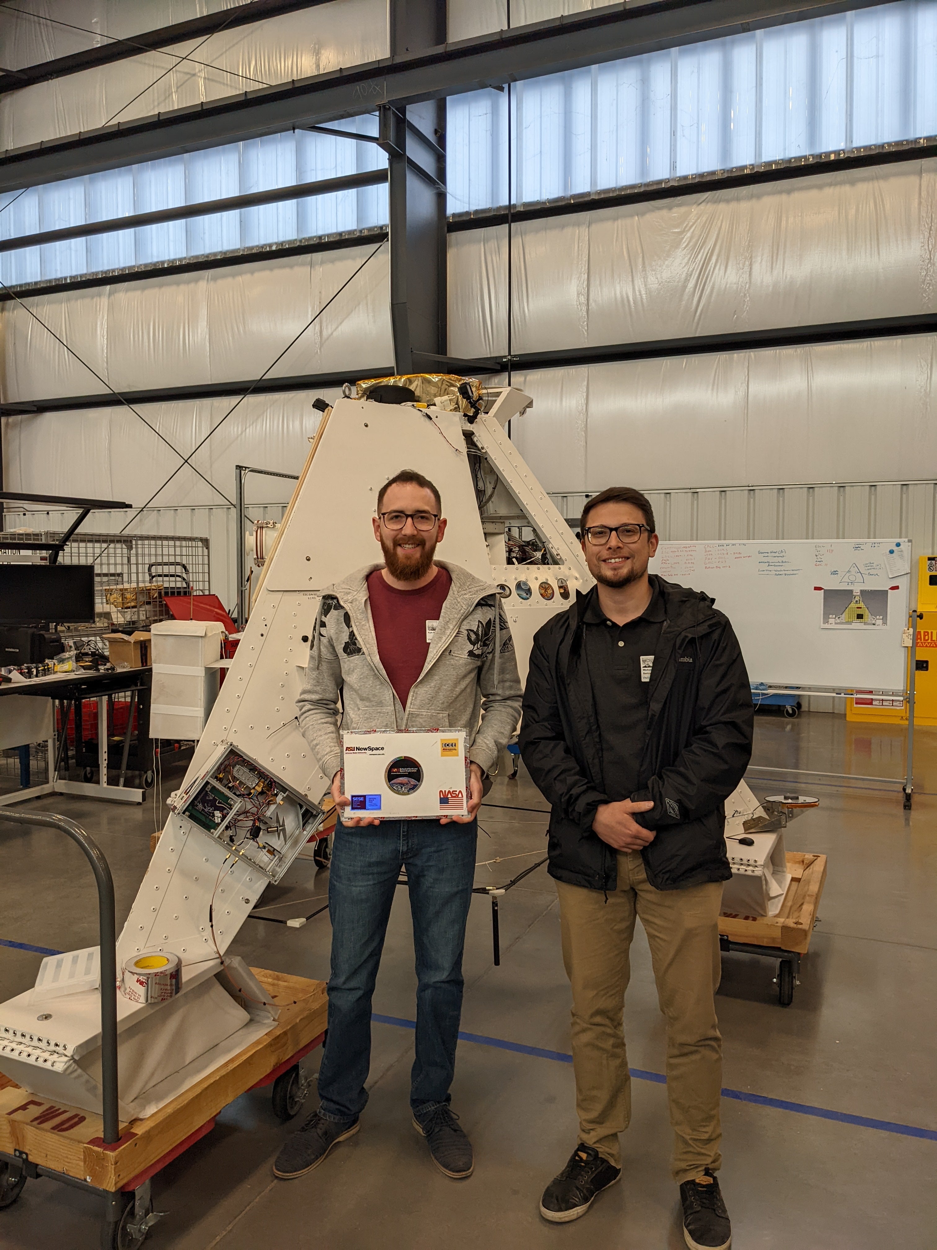 Kyle with collaborator in from of high altitude balloon vehicle