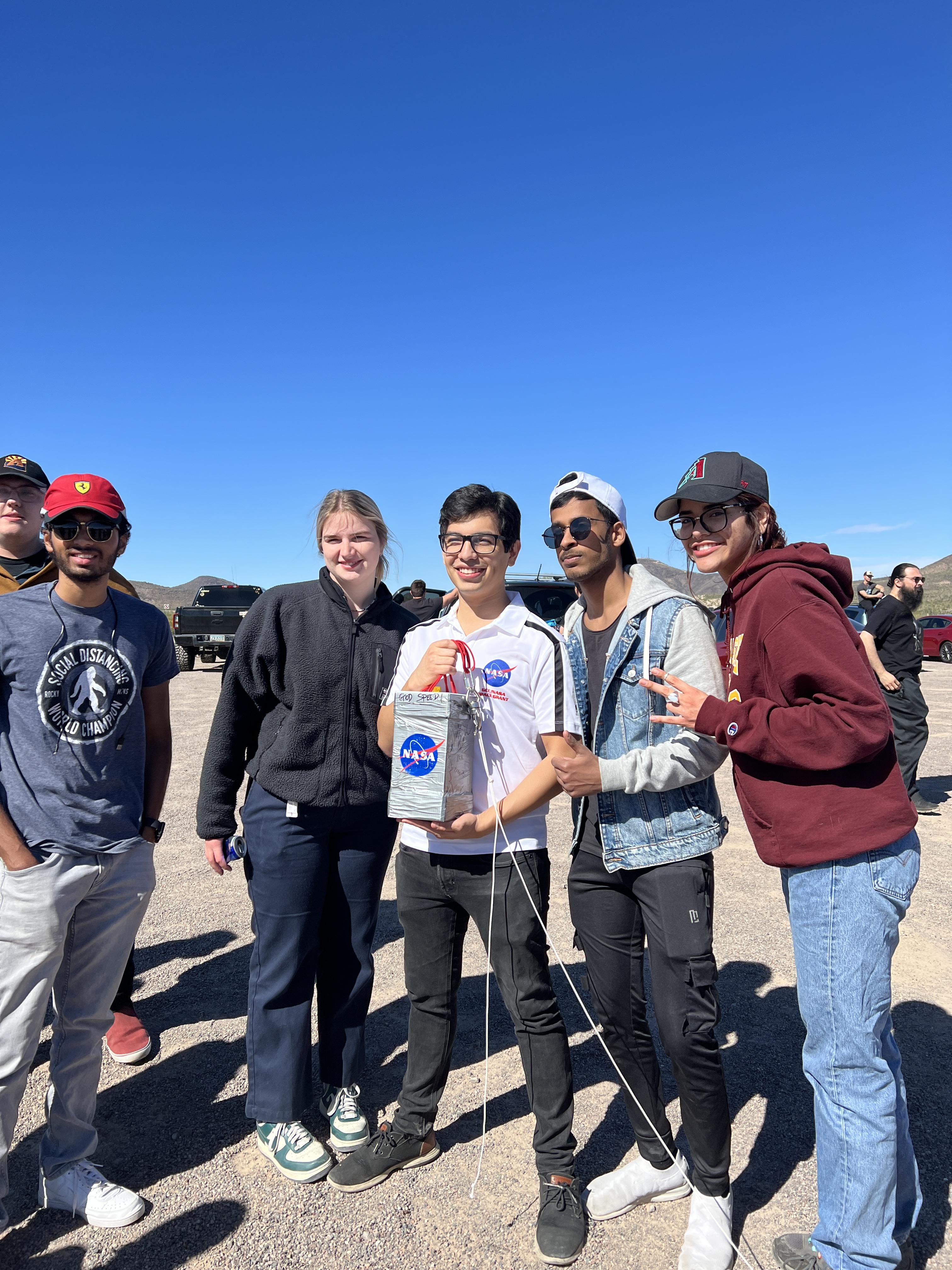 Adair pictured with team members holding Payload at ASCEND Launch Spring 2023