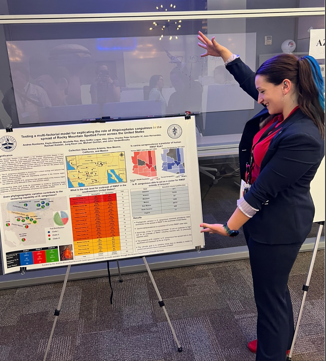 Woman showing research poster at academic conference 