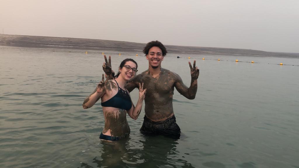 Students enjoying the Dead Sea covered in mineral rich mud