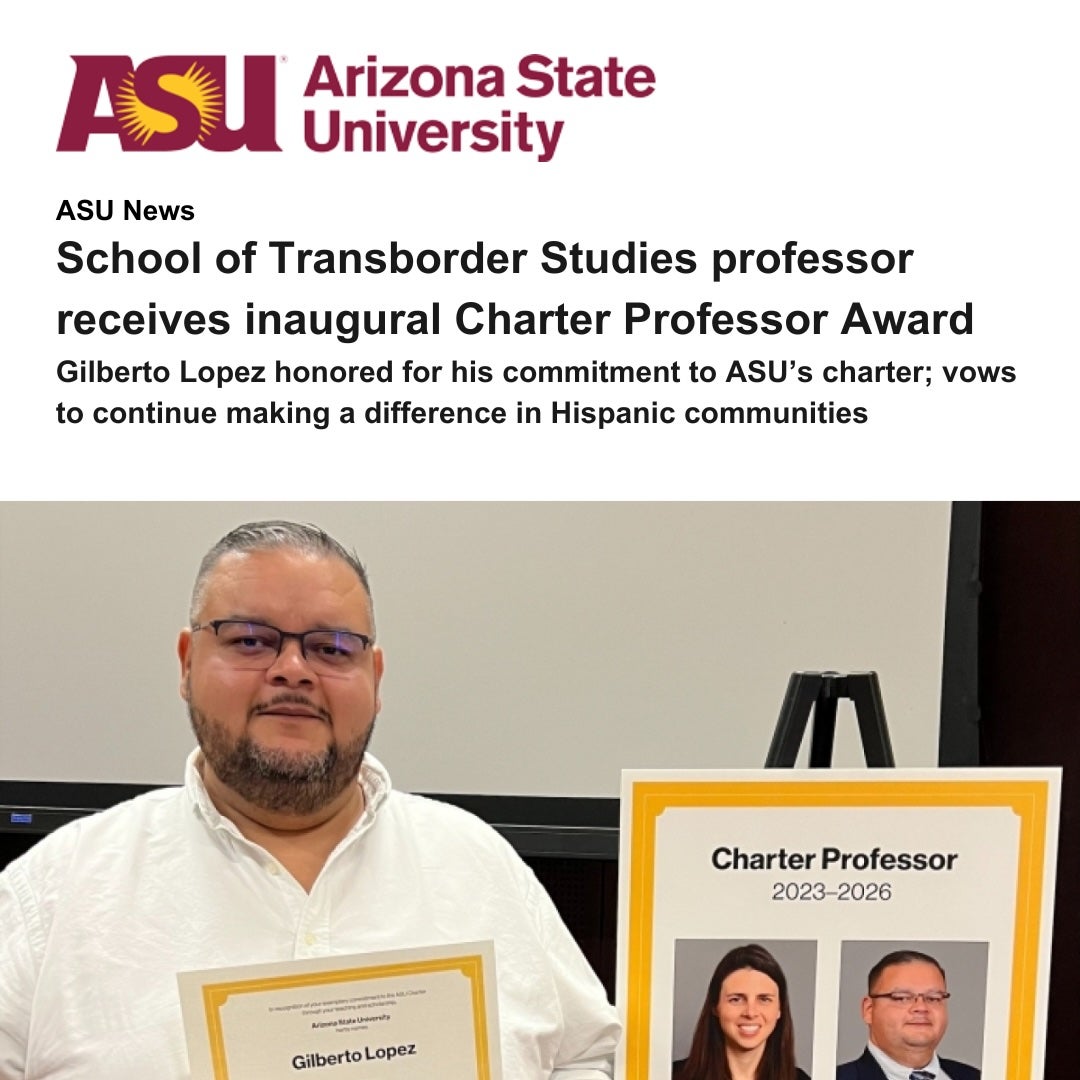 Professor Lopez holding award certificate