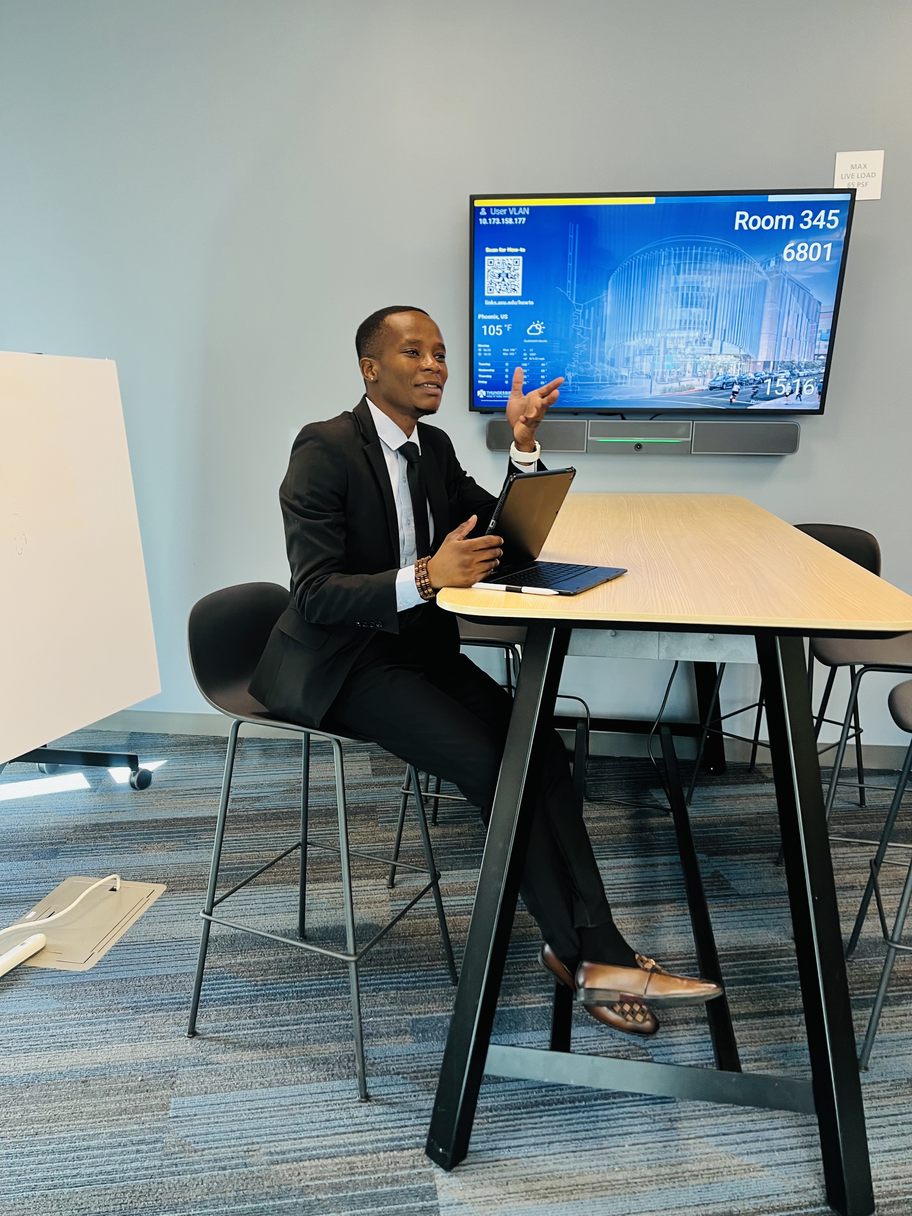 Mcebisi Moyo in formal attire at Thunderbird School of Global Management campus.
