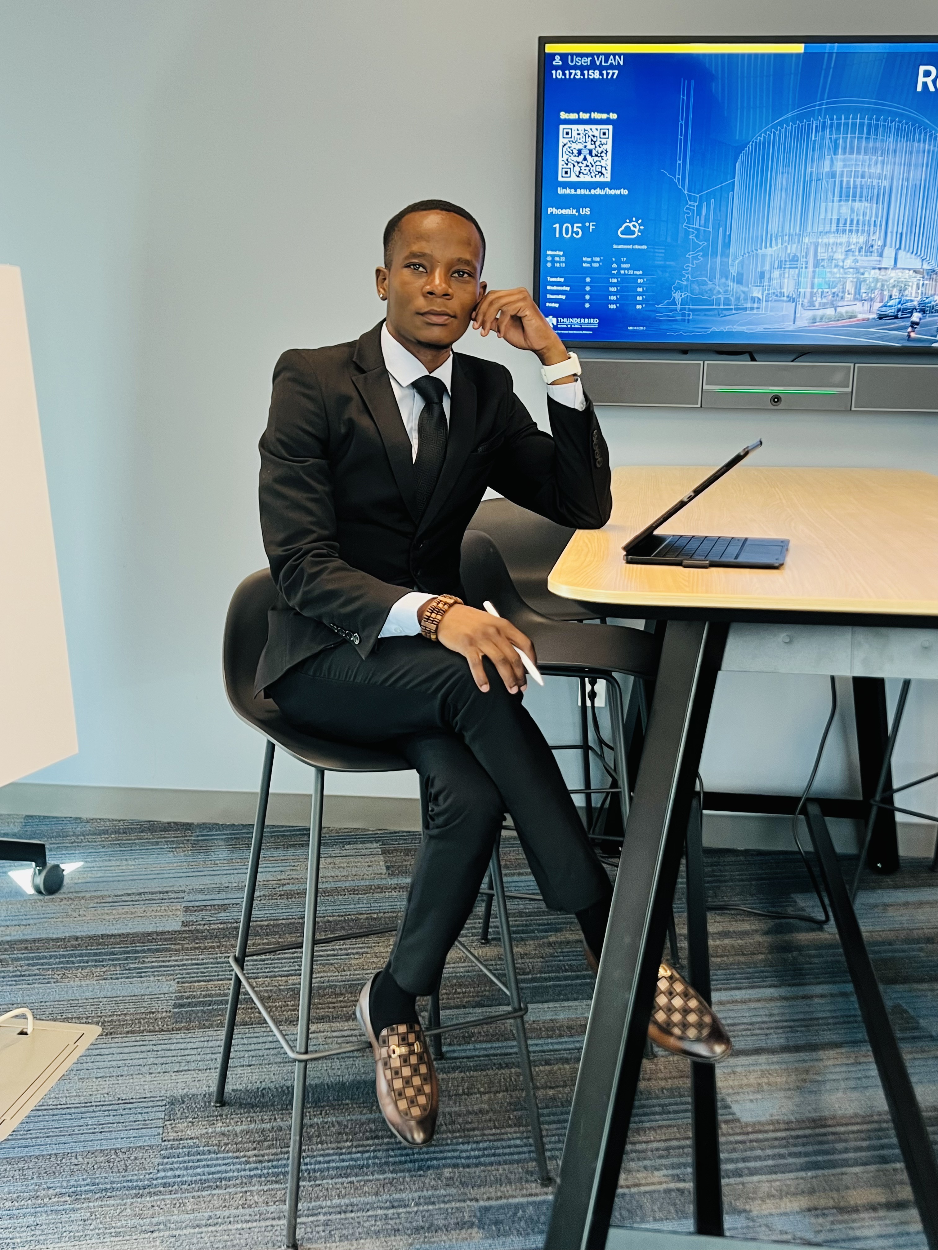 Mcebisi Moyo in formal attire at Thunderbird School of Global Management campus.