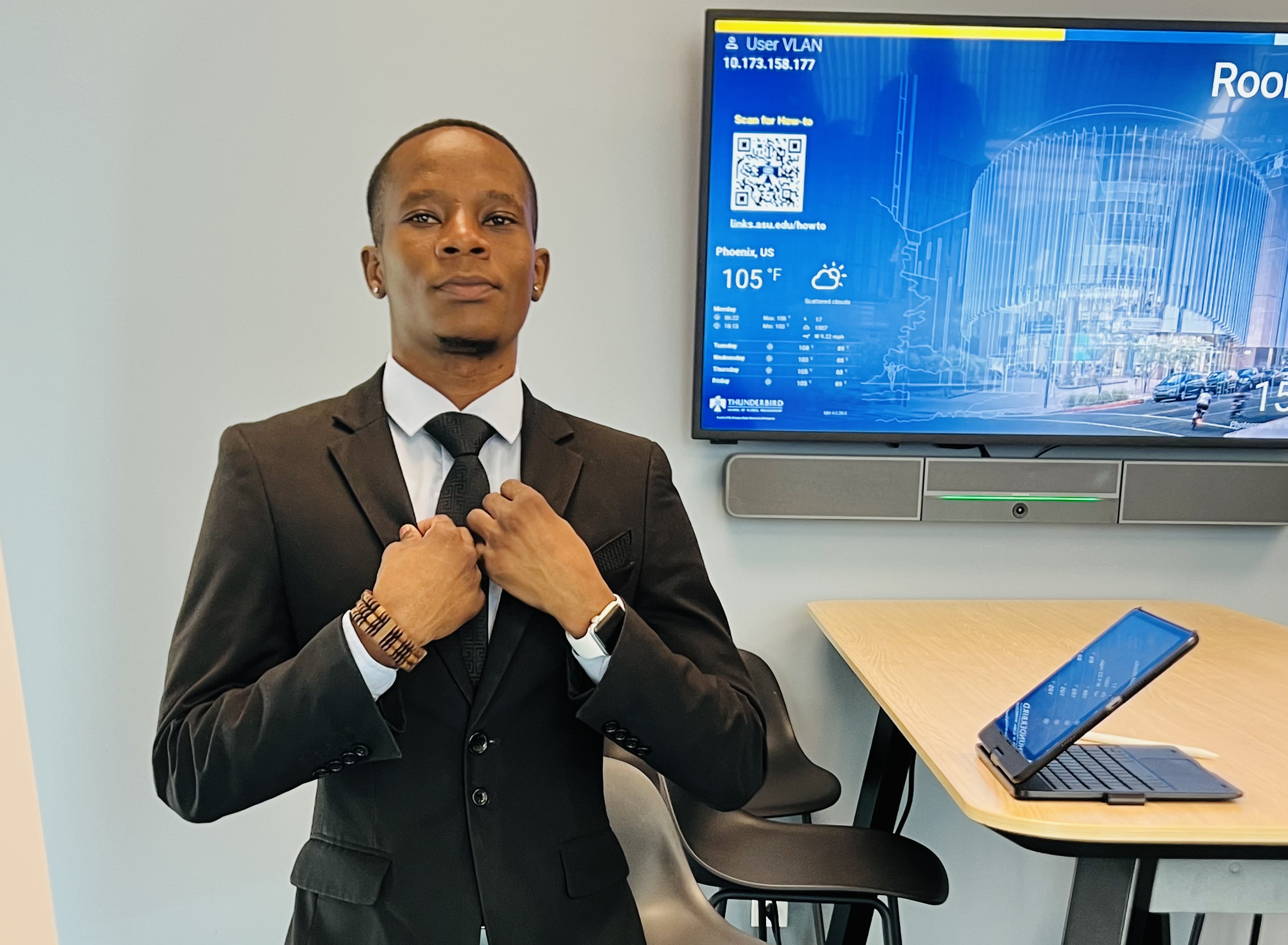 Mcebisi Moyo in formal attire at Thunderbird School of Global Management campus.