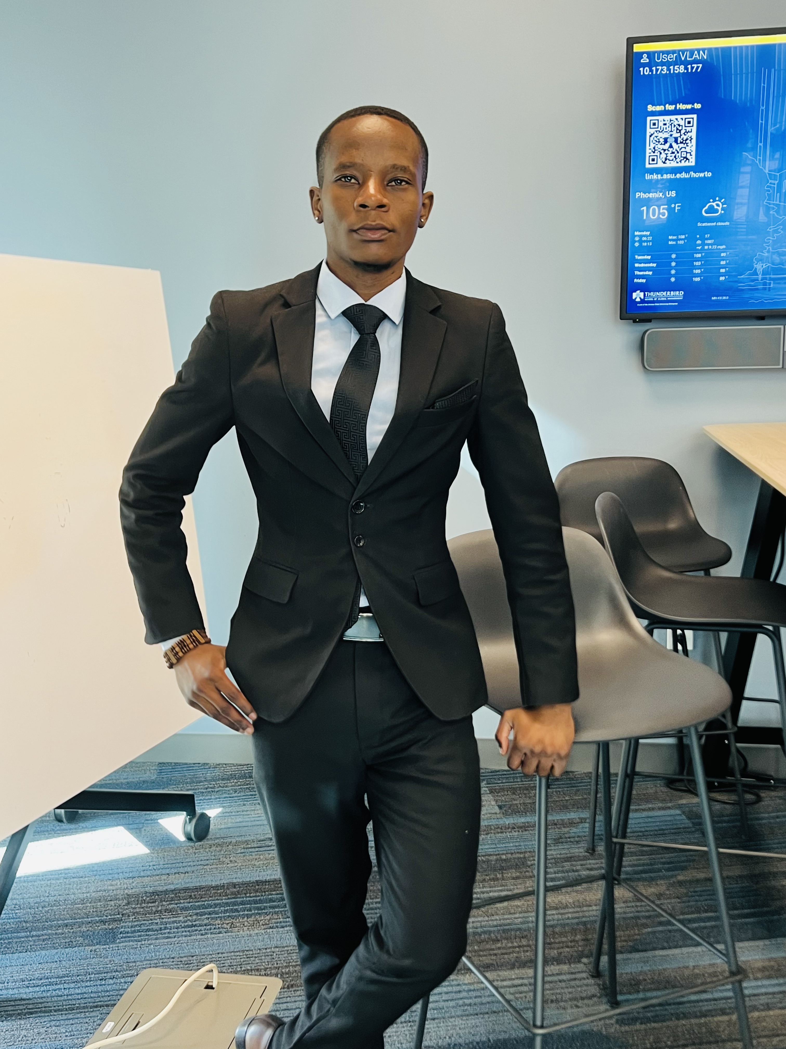Mcebisi Moyo in formal attire at Thunderbird School of Global Management campus. 