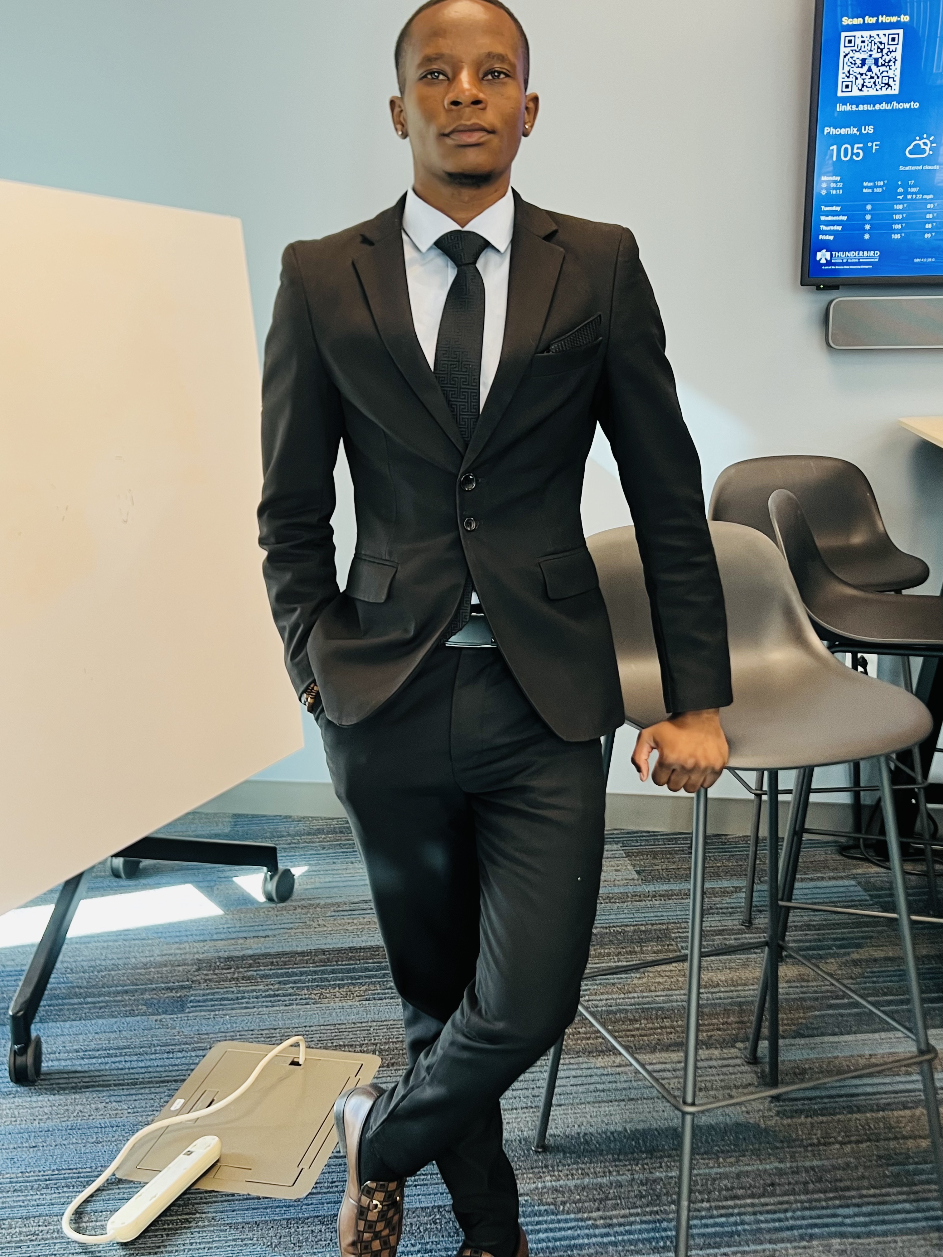 Mcebisi Moyo in formal attire at Thunderbird School of Global Management campus.