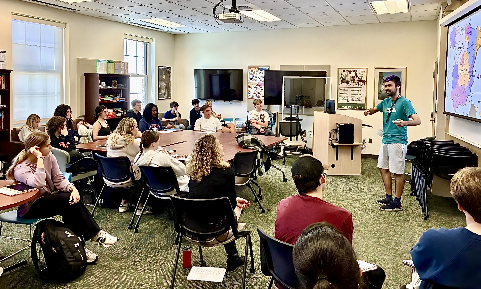 Presenter shares Spanish culture with attendees during Open House 2025 through an interactive presentation featuring traditions, festivals, and community life in Spain.
